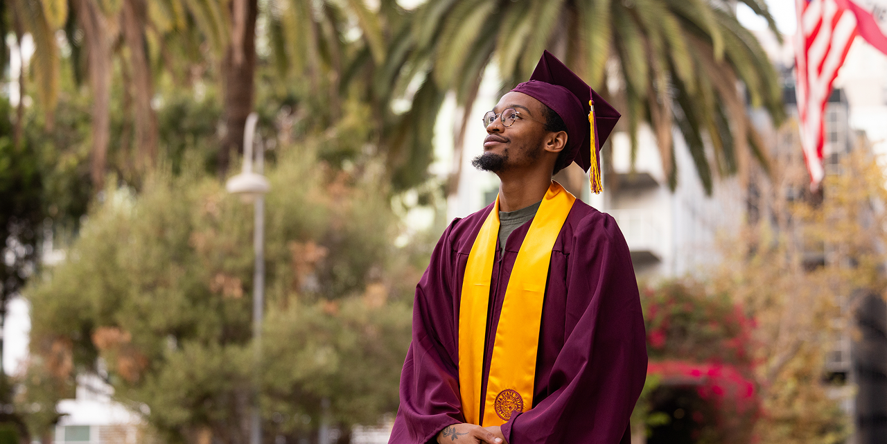 Graduate in burgundy cap and gown with a gold stole beside a scholarship announcement for California Community College students.